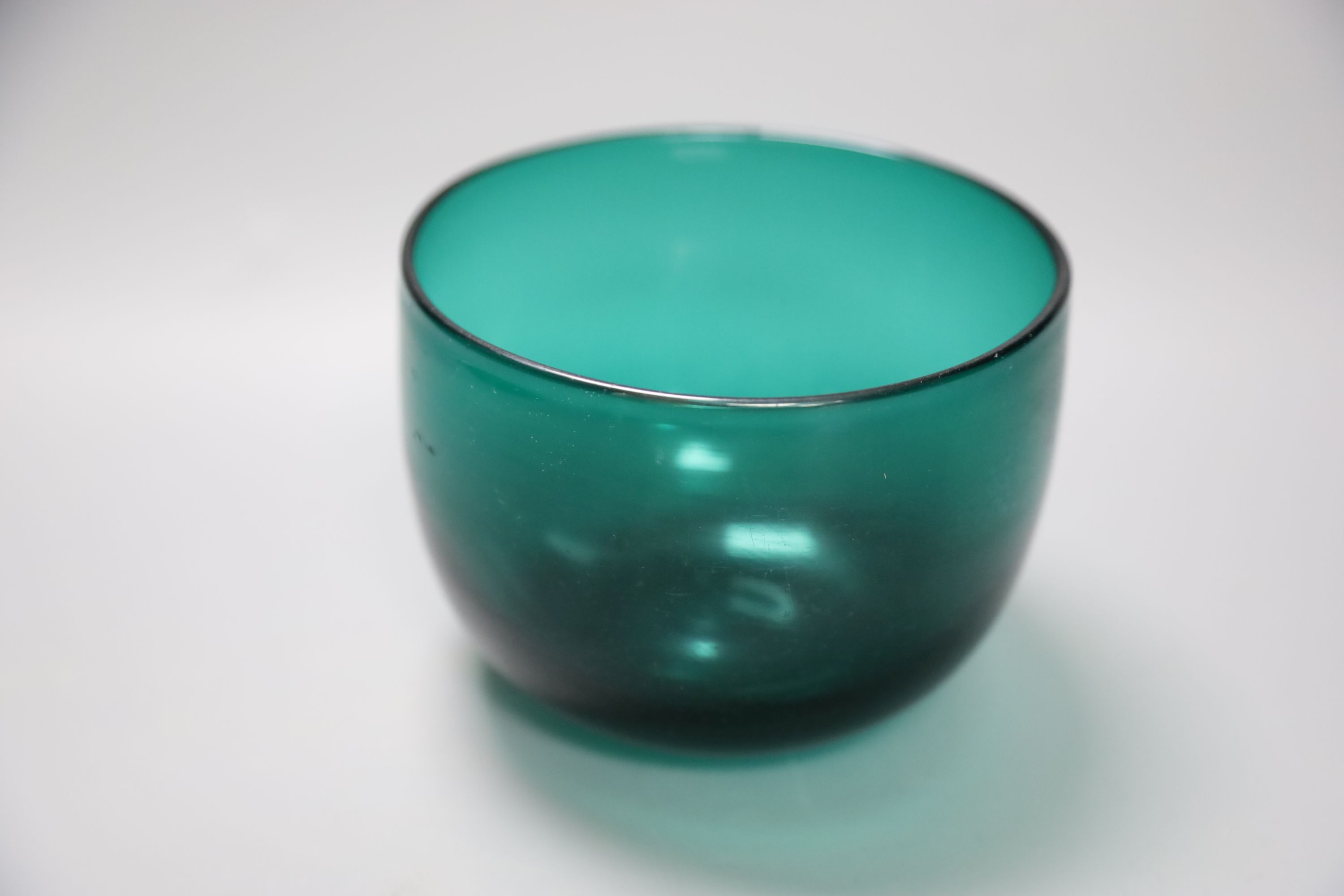 A group of 19th century green glass and a Victorian dump paperweight